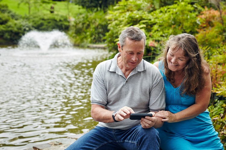 Couple sitting by a pond